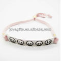 silver alloy carved phiz symbol with pink leather bracelet